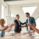 employee retention meeting in the modern office shaking hands | Firstbird