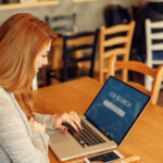 young woman searching job online in cafe
